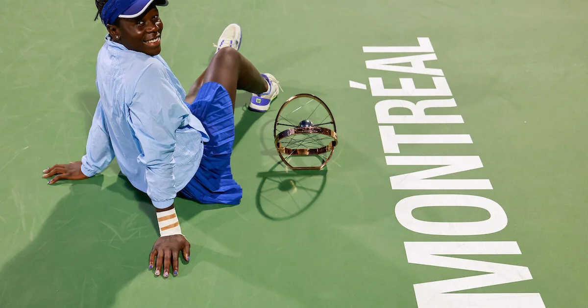 Victoria Mboko sits beside the trophy after winning the 2025 National Bank Open in Montreal